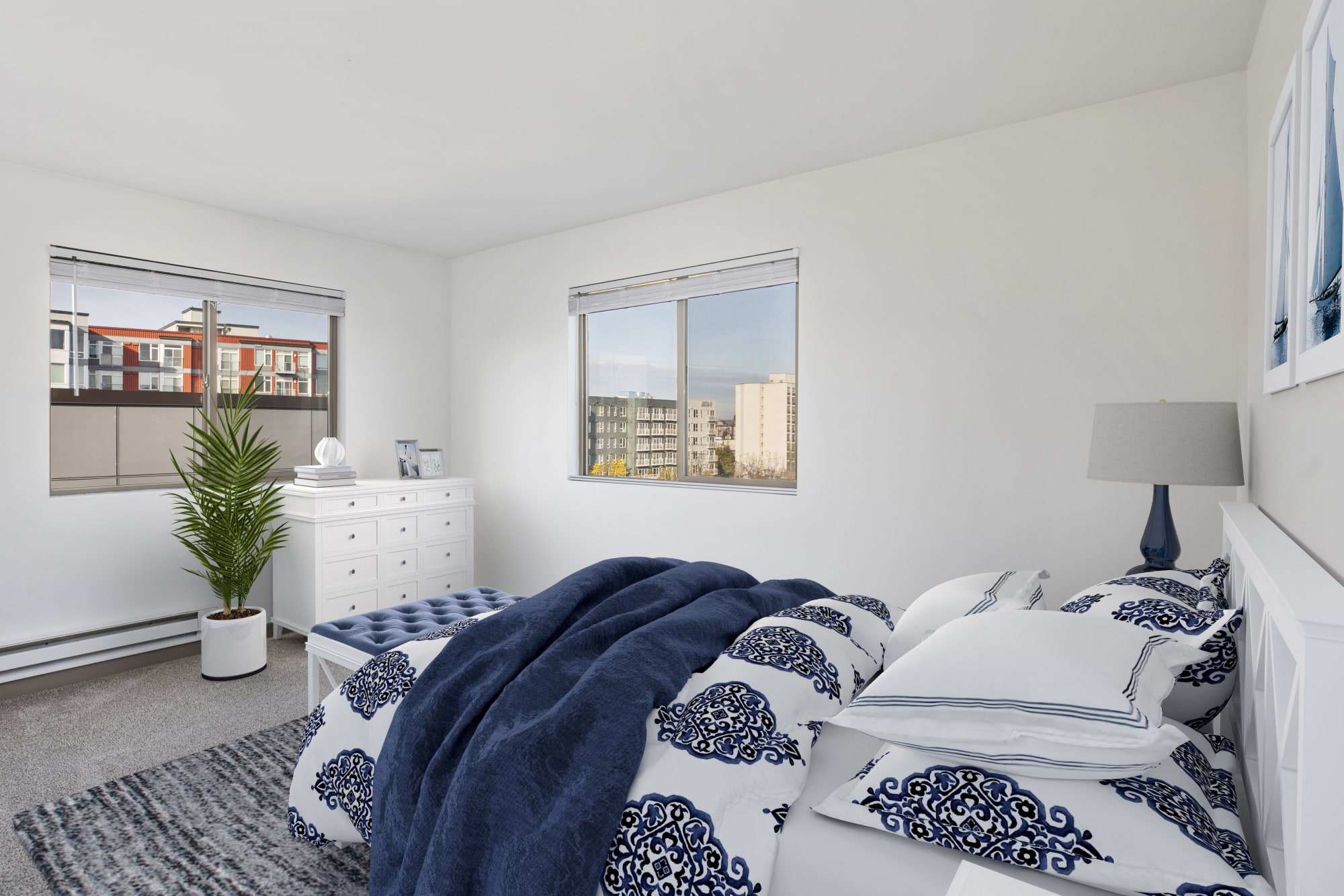 A bedroom with cityscape views at Elan 41 Apartments in Seattle, Washington