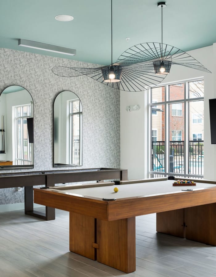 Game room with pool and shuffleboard at The Blake in Kennesaw, Georgia