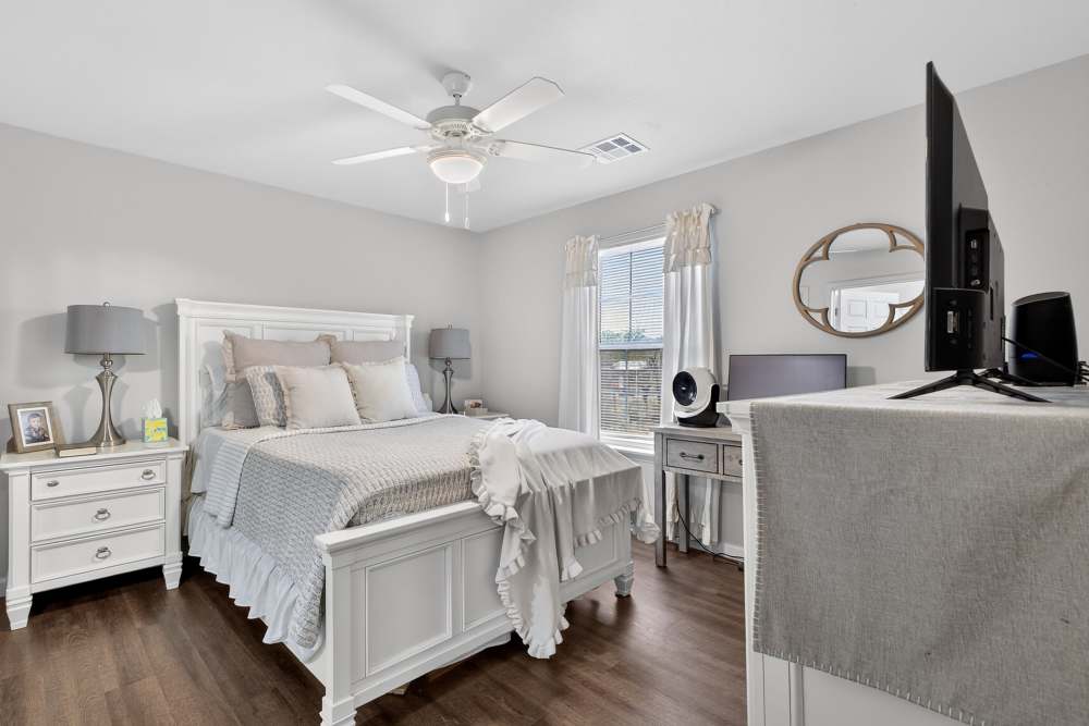 Charming bedroom with soft natural light and modern decor at Lakewood Crossing in Granbury, Texas.