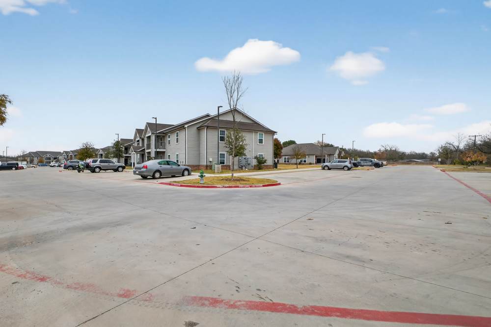 Charming community setting with well-maintained parking and lush landscaping at Lakewood Crossing in Granbury, Texas.