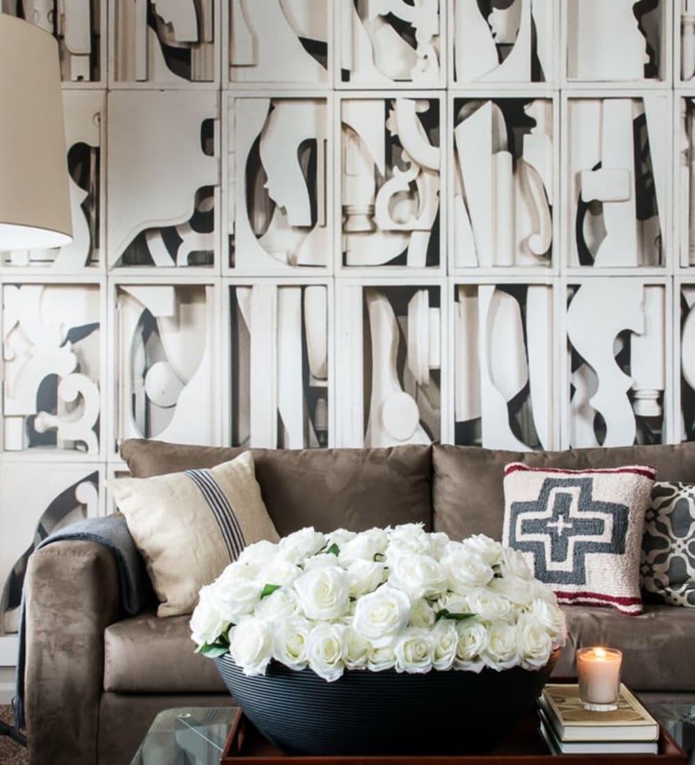 Model living room with abstract wall art in a student apartment at Campus Quarters in Corpus Christi, Texas