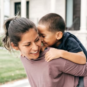 Resident and son outside of their home at Pecan Ridge in Waco, Texas