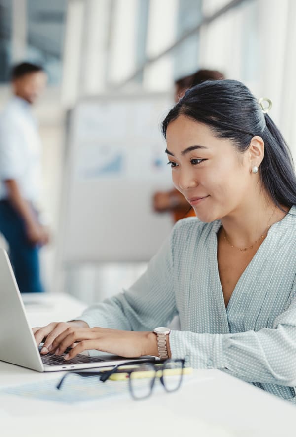 Resident working on her computer at Quantum Leap Property Management in Austin, Texas