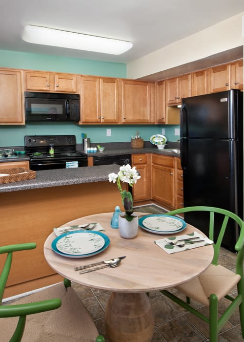 Eat-in kitchen with black appliances at James River Pointe in Richmond, Virginia