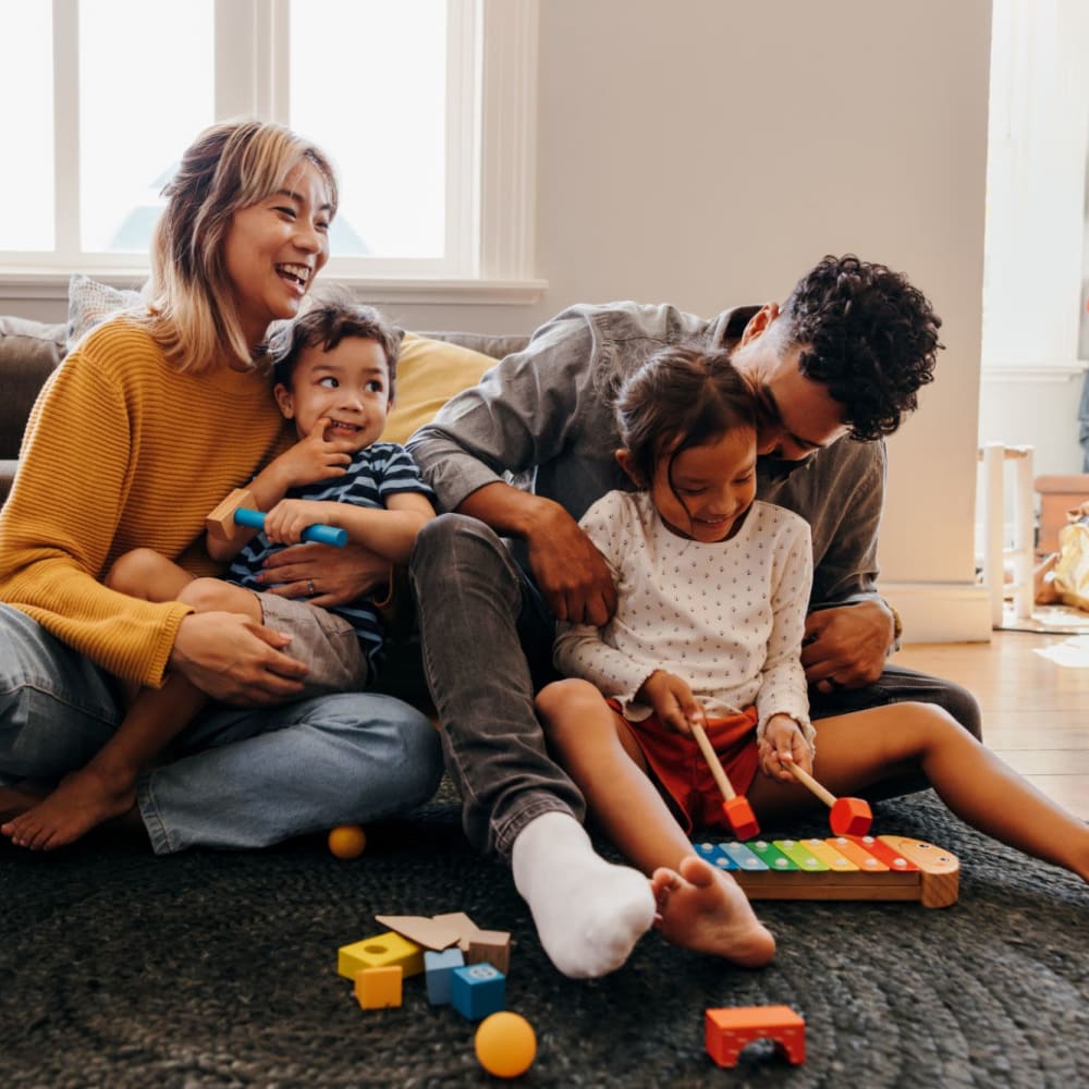 Residents enjoy family time in their apartment at Fox Plan Apartments, Monroeville, Pennsylvania