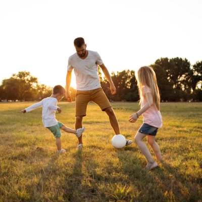 Father playing with his kids near Lemon Bay Apartments in Englewood, Florida