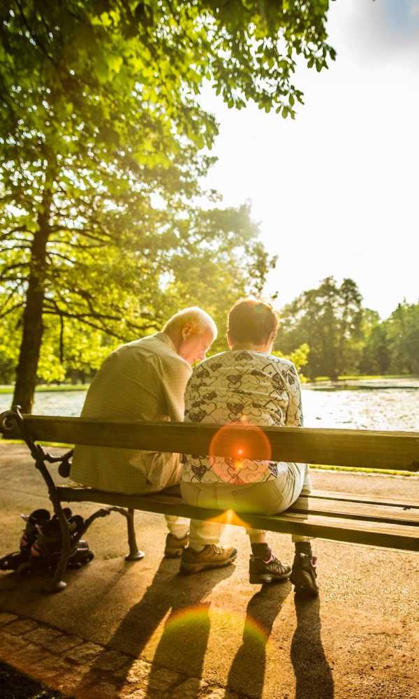 Residents sitting on bench at The Abbey at Riverchase in Hoover, Alabama