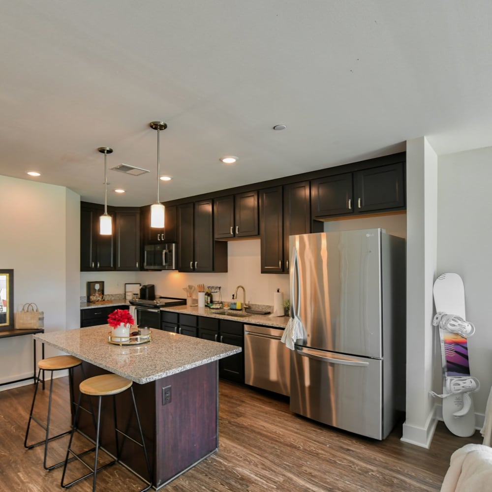 Kitchen with stainless-steel appliances and wood-style floors at Crossroad Towers, Pittsburgh, Pennsylvania