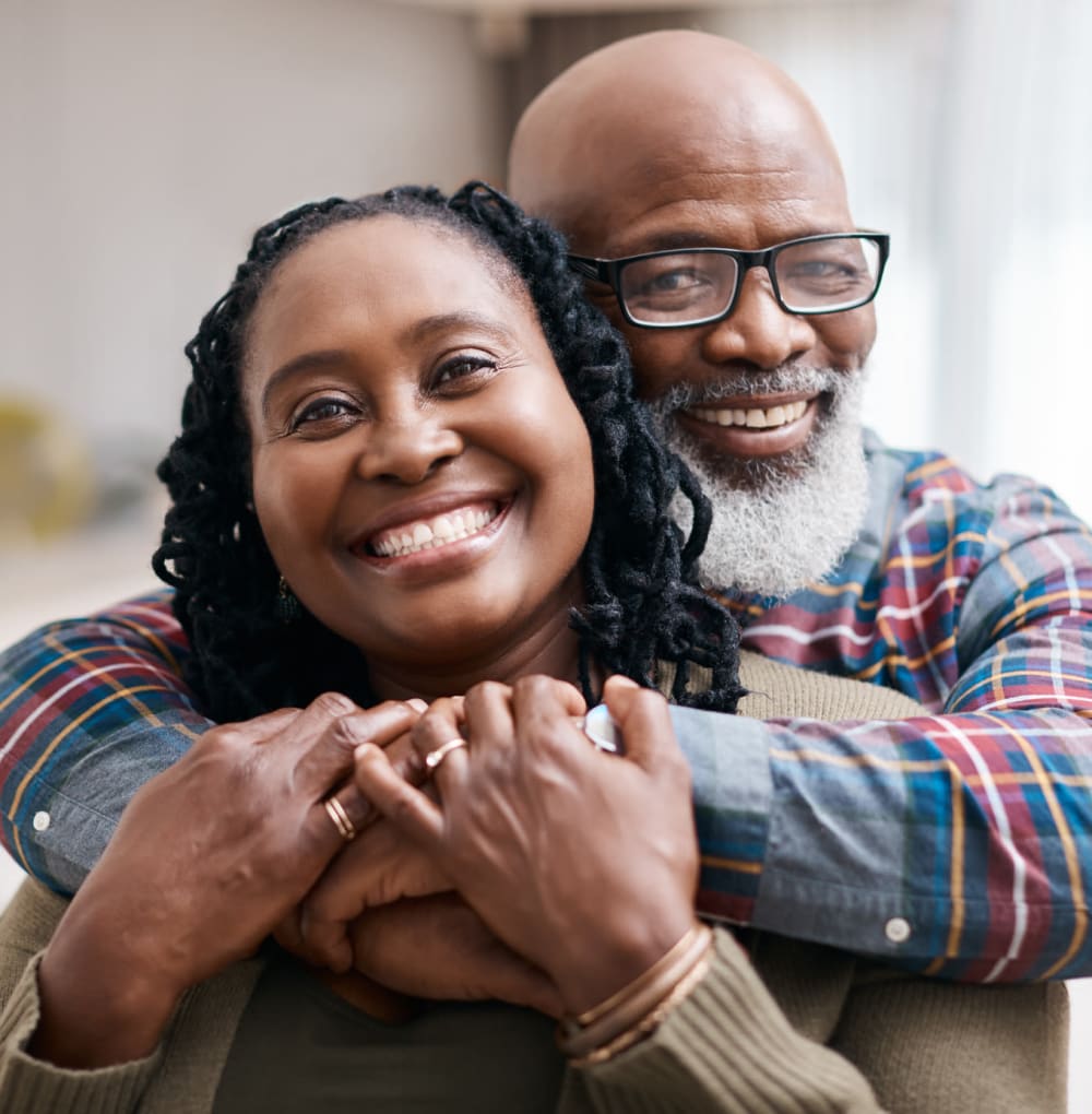 Resident couple hugging in their apartment at Blossom Ridge in Oakland Charter Township, Michigan