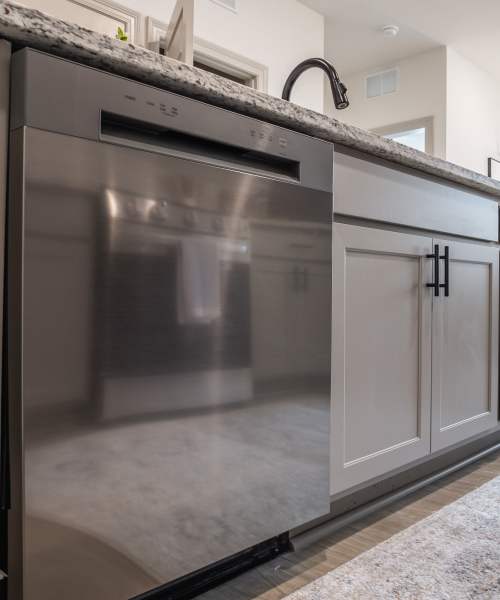 Modern kitchen with built-in dishwasher at The Flats at Crosspointe in Columbia, South Carolina