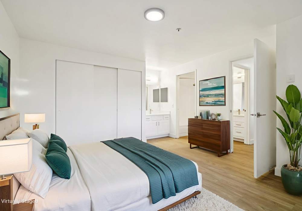 Bedroom with bed and dresser and has a sink and closet at Foundry on Fifth in Renton, Washington