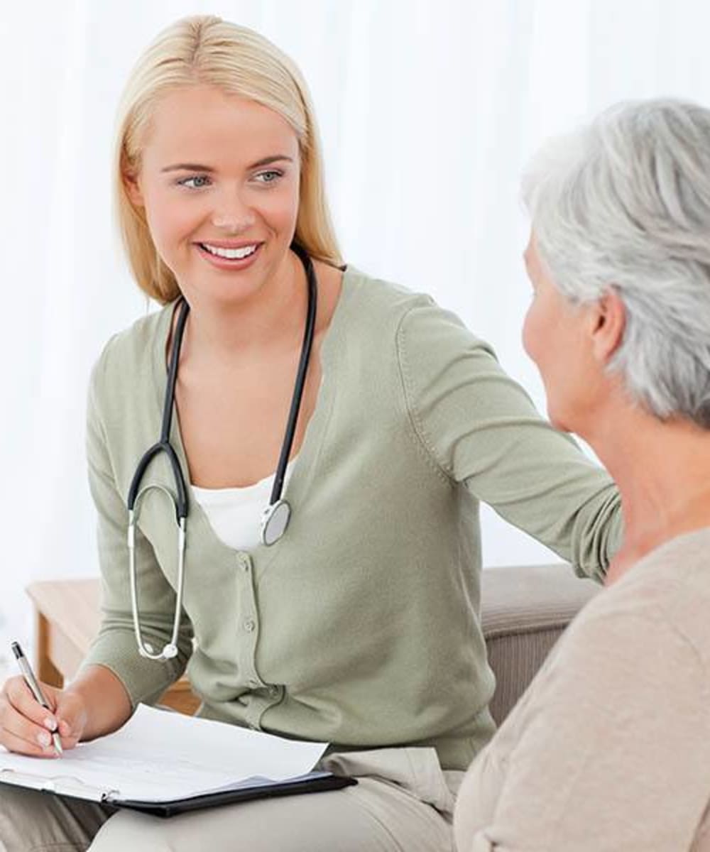 A caregiver talking with a resident at Brightwater Senior Living of Linden Ridge in Winnipeg, Manitoba