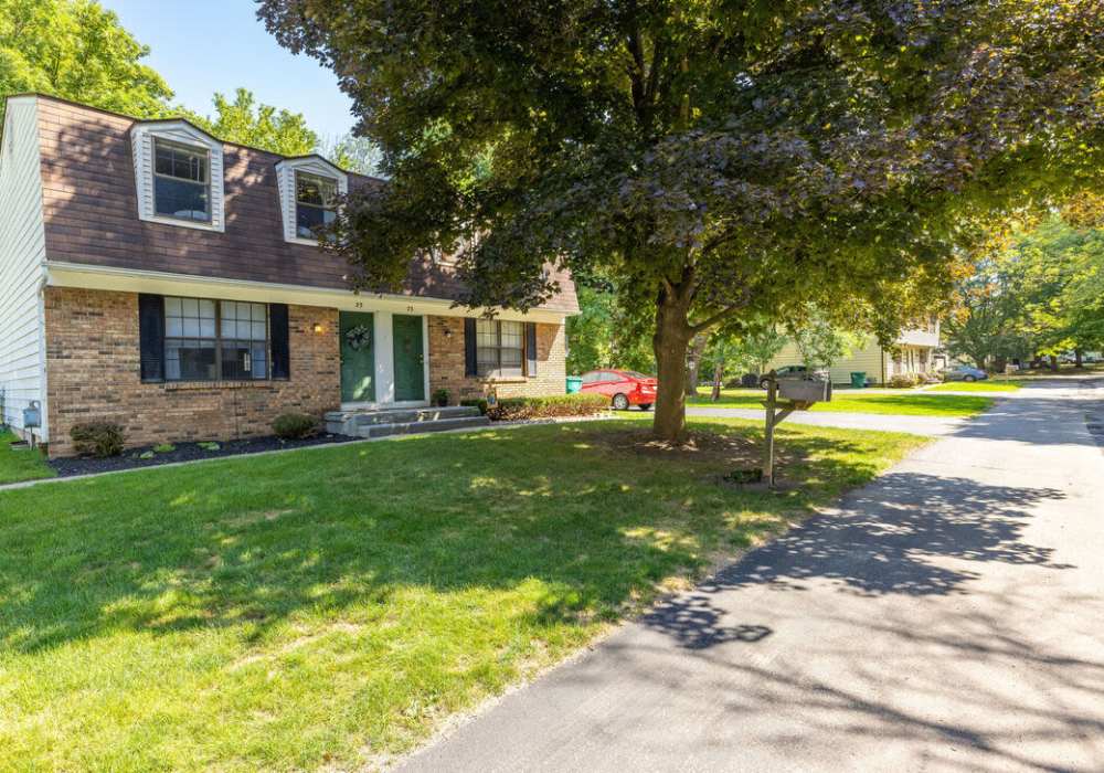Charming home with a spacious yard and trees at Jefferson Manor Townhomes in Fairport, New York
