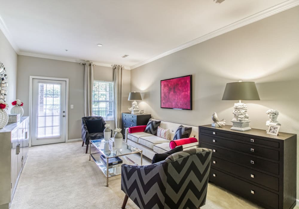 Bright and open living room with access to patio or balcony and room for chairs, couch, coffee table, and media chest at Glass Creek in Mt Juliet, Tennessee