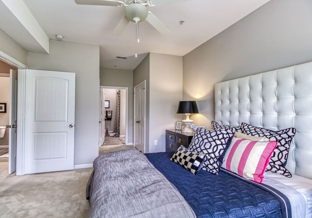 Bedroom with connecting bathroom with queen-sized bed, cushion headboard, and ceiling fan at Glass Creek in Mt Juliet, Tennessee