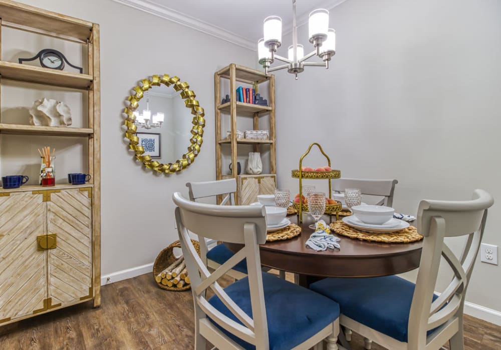 Dining room with hard-wood flooring, round table, and four chairs at Everwood at The Avenue in Murfreesboro, Tennessee