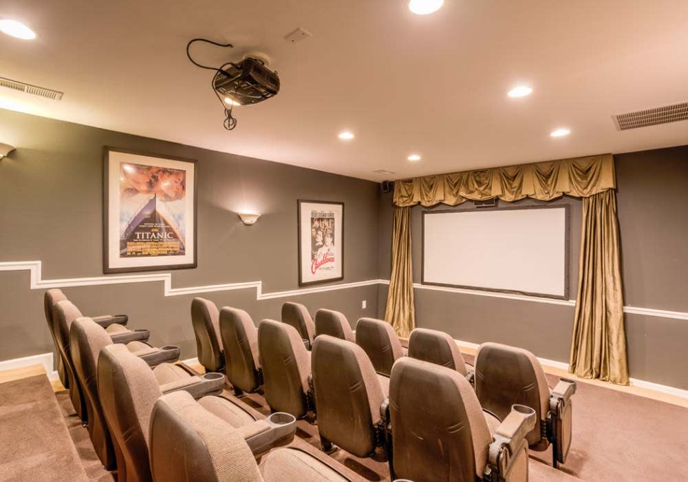 Luxury community movie theater with seats with cupholders for beverages and snacks at Deer Meadow Village in Columbia, South Carolina 