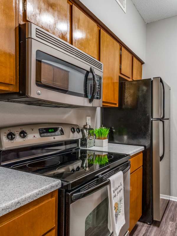 Kitchen with range and refrigerator at Argosy at Crestview in Austin, Texas