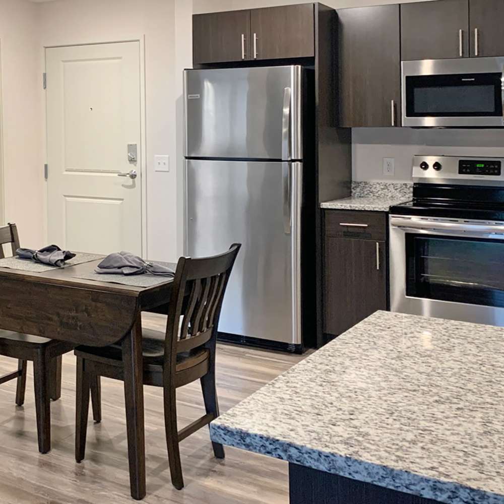 Kitchen with stainless-steel appliances at Depot on Main in Zimmerman, Minnesota