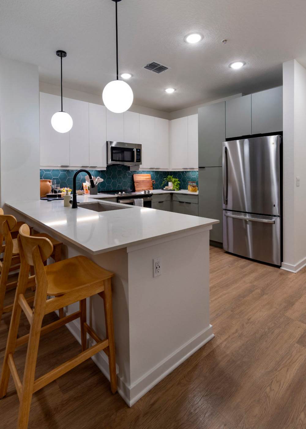 Kitchen with bar stools at Evergreen Mills 50 in Orlando, Florida