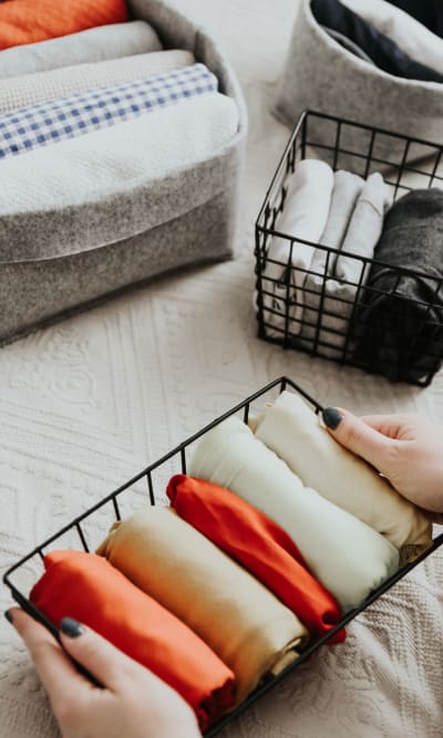 Resident folding clothes at Cosmopolitan Apartments in Pittsburgh, Pennsylvania