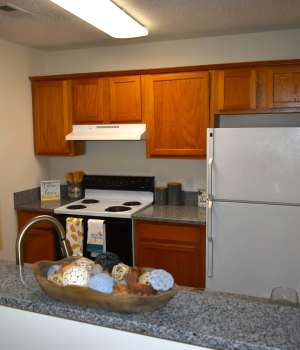 Modern kitchen with wooden cabinets at Riverfront in Mount Holly, North Carolina