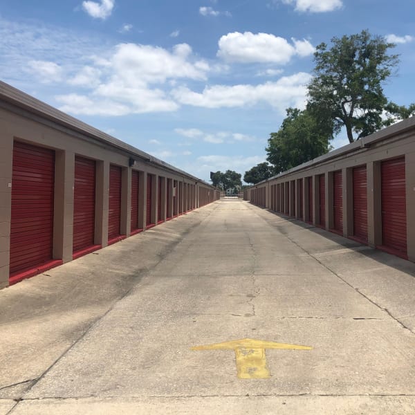 Outdoor storage units with red doors at StorQuest Self Storage in Tampa, Florida