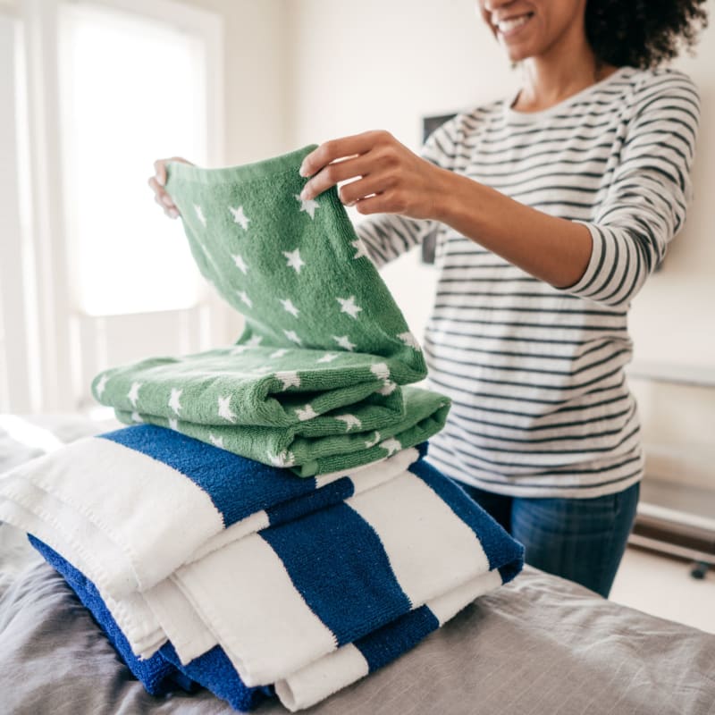 A resident folds laundry in her apartment at Commons on Potomac Square, Sterling, Virginia