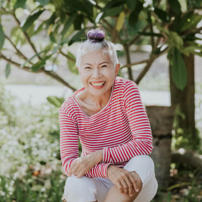 Happy resident on a beautiful day at a senior living community by Cascade Senior Living Services