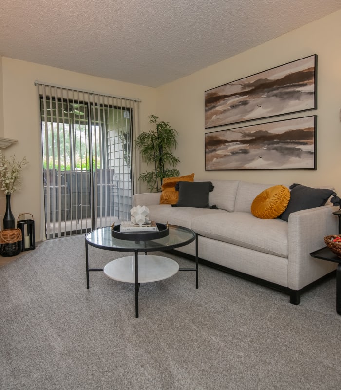 Carpeted living room at Sugarberry Apartments in Tulsa, Oklahoma