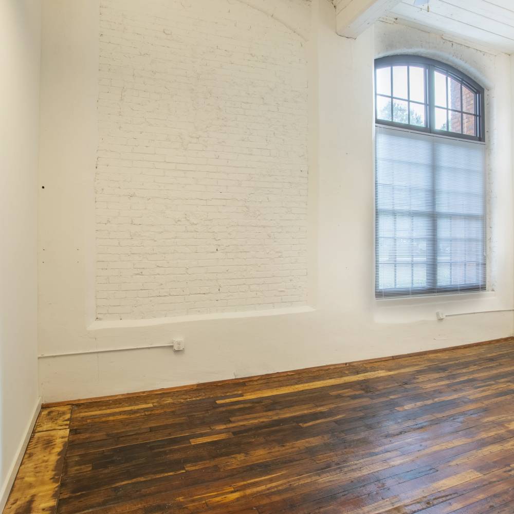 Wood-style floored living area at Lofts at Inman Mills in Inman, South Carolina