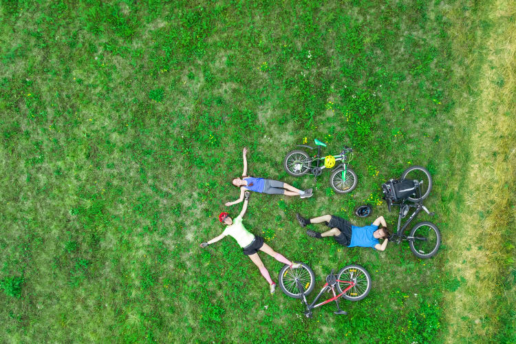 Residents relaxing on the grass during a bike ride near Evolv in Mansfield, Texas