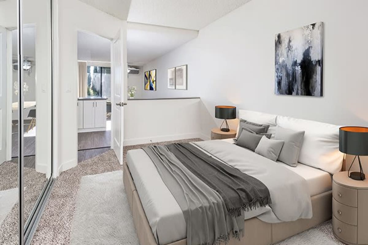 Bedroom with mirrored closet doors at Villa Careena, West Hollywood, California