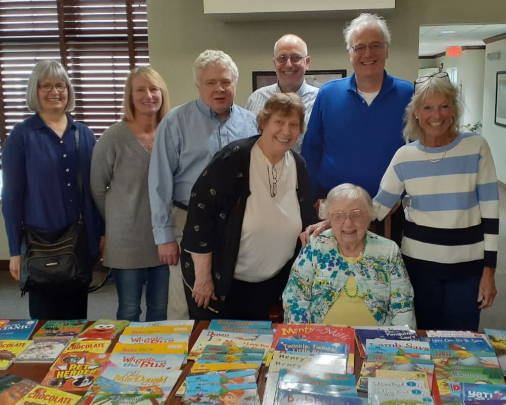 Resident Alice and family with books donated for her dare to dream event at Clover Ridge Place in Maquoketa, Iowa.