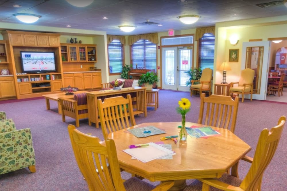 Room with a lot of seating and a TV at Addington Place of Ottumwa in Ottumwa, Iowa