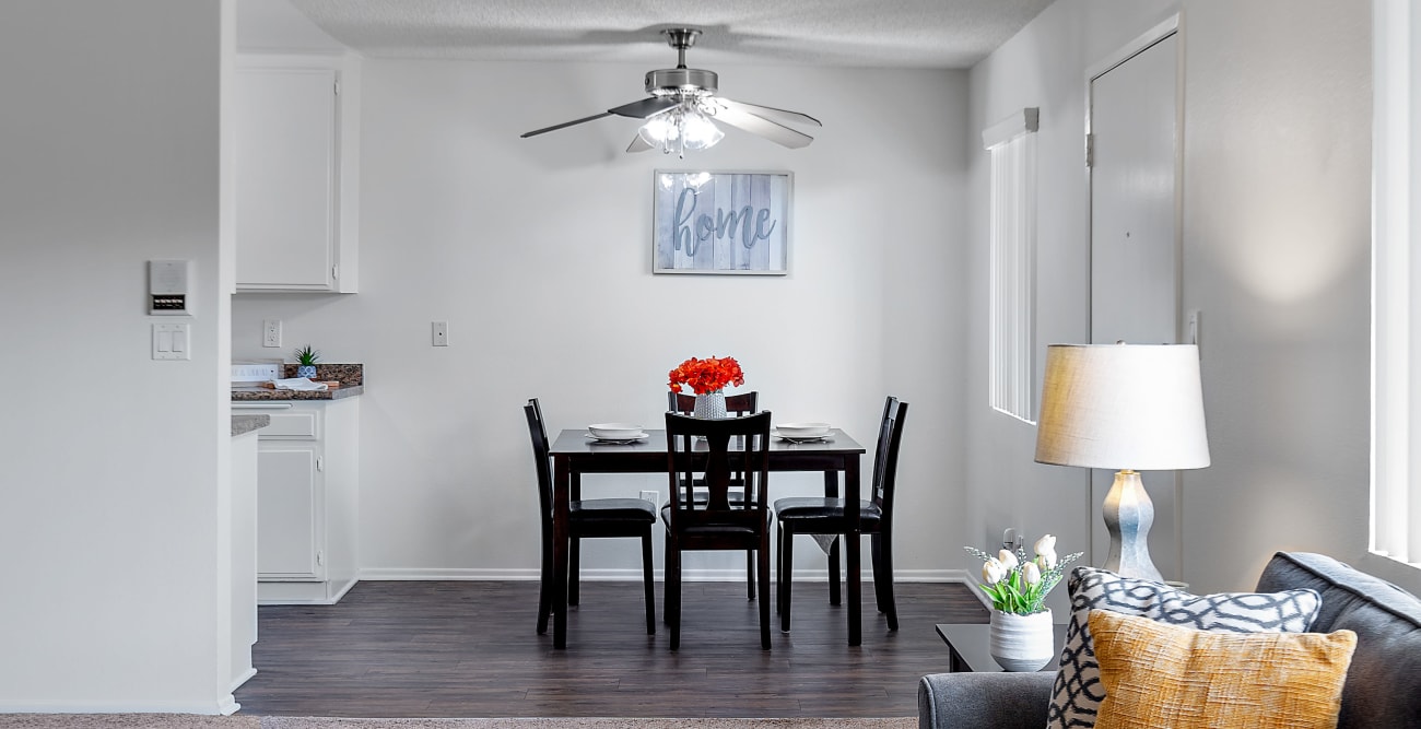 View of the dining room with plank flooring from the living room at the Hallmark Apartment in Sherman Oaks, California