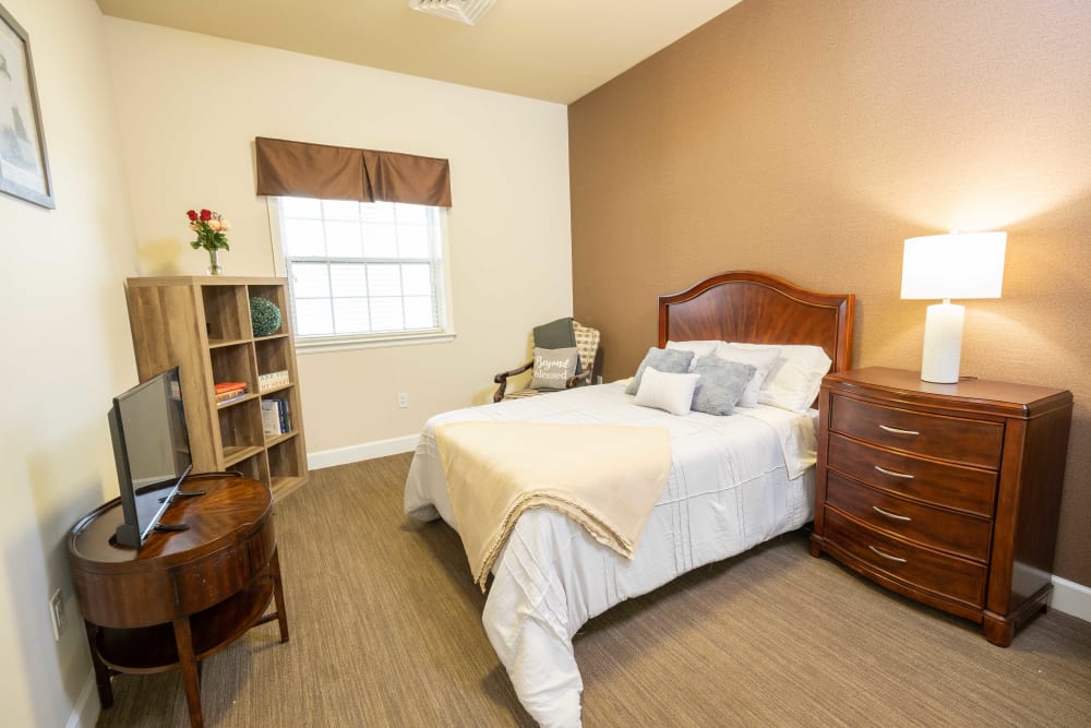 Model bedroom with wood flooring at The Heritage of CyFair in Houston, Texas