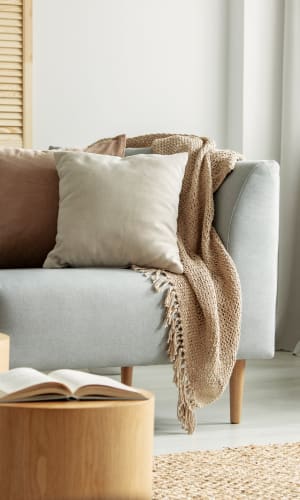 Model living room couch at Dove Hollow Apartments in Allen, Texas