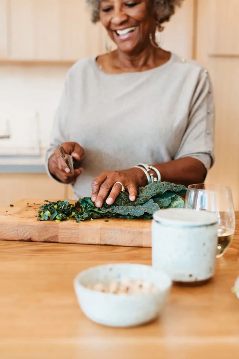 Resident chopping kale at Carriage Inn Lake Jackson in Lake Jackson, Texas