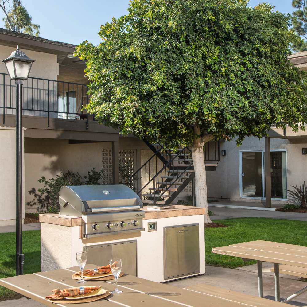 Outdoor seating space with grilling area at Orange Grove in Garden Grove, California