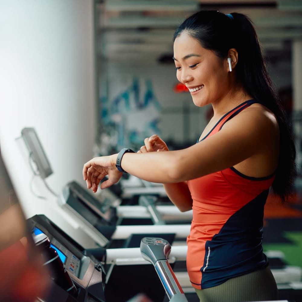 A woman working out in the fitness center at Settlers Ranch Apartments in Houston,Texas