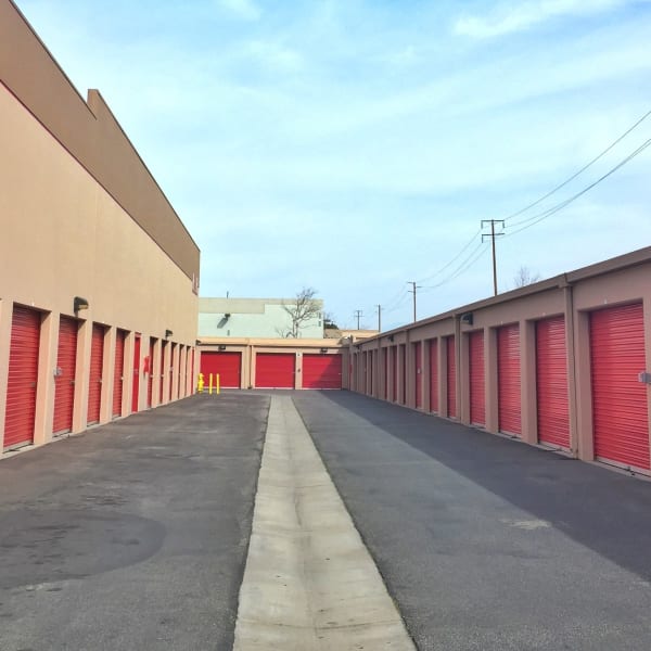 Outdoor storage units with red doors at StorQuest Self Storage in Oxnard, California