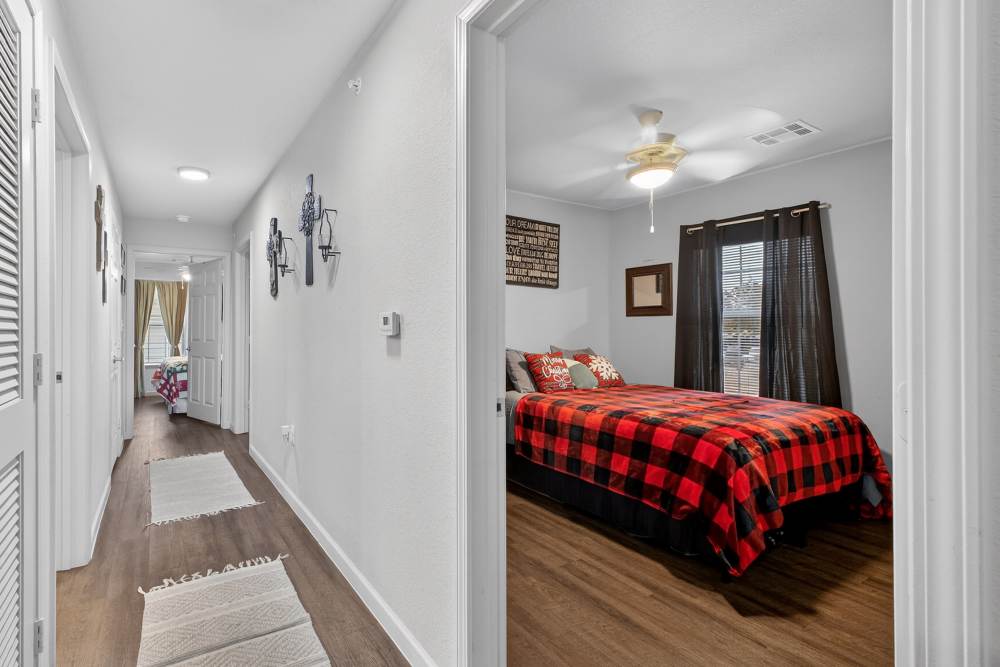 Charming bedroom with cozy decor and warm natural light at Lakewood Crossing in Granbury, Texas.