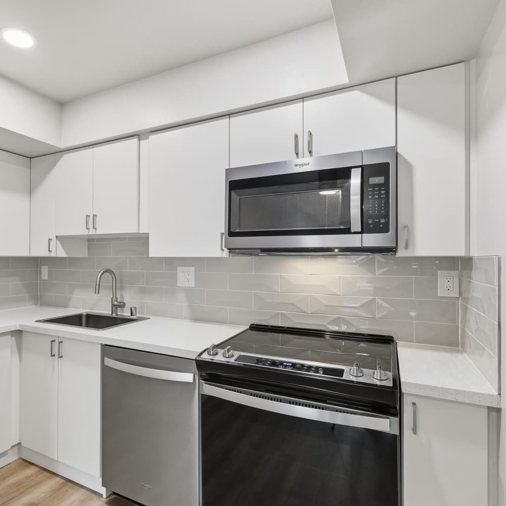 Kitchen with white cabinets and stainless steel appliances at Fayette Arms Apartments in Mountain View, California, 