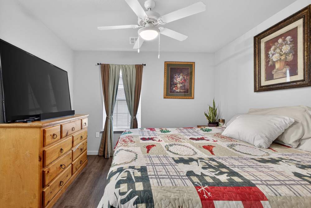 Charming bedroom with wooden accents and cozy decor at Lakewood Crossing in Granbury, Texas.