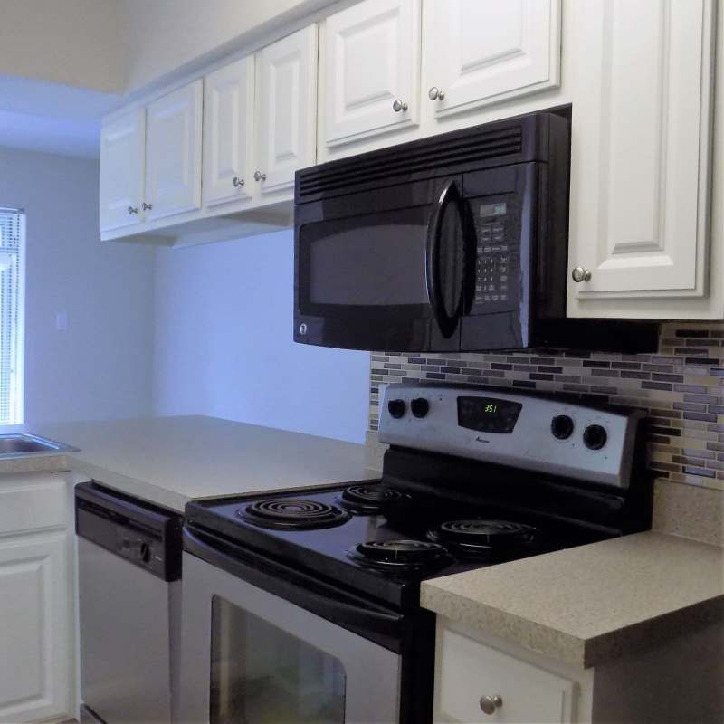 Apartment kitchen with modern appliances at Branch Creek Apartments in Carrollton, Texas