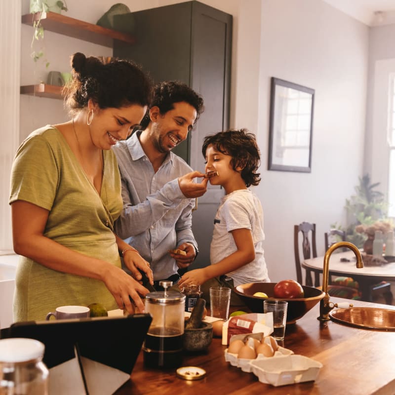 A family prepares a meal in their kitchen at Attain at Harbour View, Suffolk, Virginia