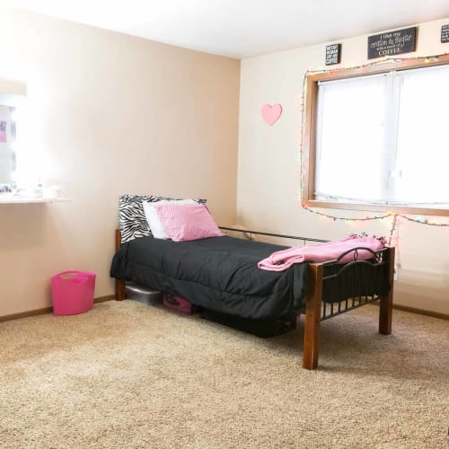 Apartment bedroom with furniture at Stone Court in Ames, Iowa