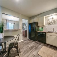 Modern kitchen with hardwood floors at London House Apartments in Lenexa, Kansas