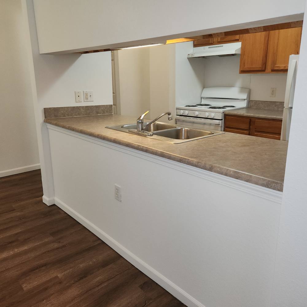 Apartment kitchen with countertops at Woodbrook Apartments in Three Rivers, Michigan